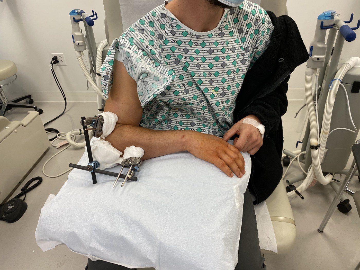 My husband in the hospital with his broken elbow, November 2020.