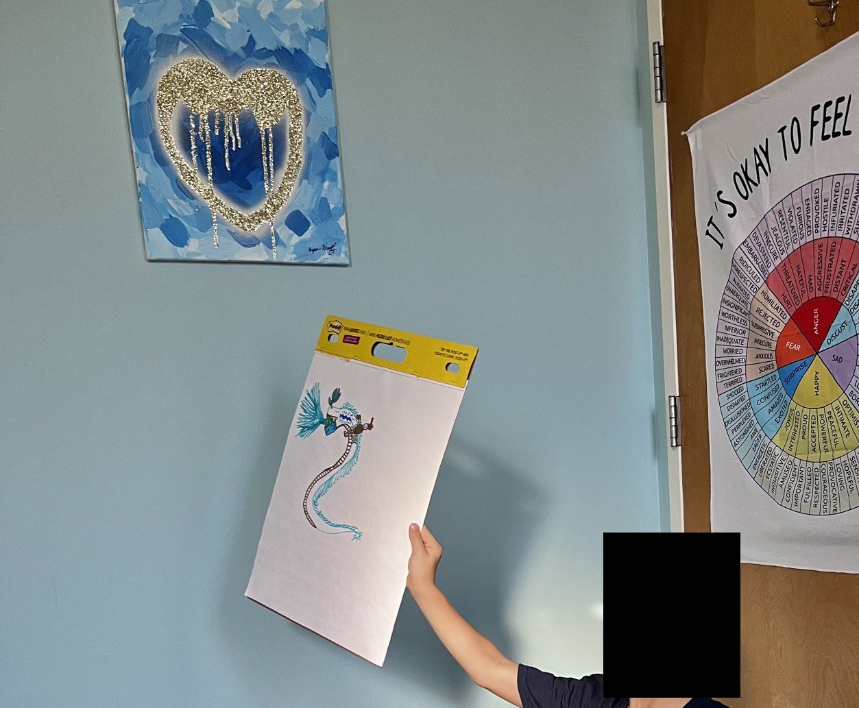 One of my boys with a drawing, November 2022.